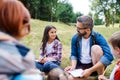 Group of school children with teacher on field trip in nature, learning science. Royalty Free Stock Photo