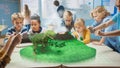Group of School Children Use Digital Tablet Computers with Augmented Reality App, Looking at