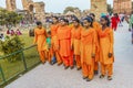 group of school girls pose in front of Qutb Minar