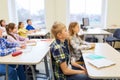 Group of school kids with notebooks in classroom Royalty Free Stock Photo