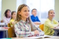 Group of school kids with notebooks in classroom Royalty Free Stock Photo