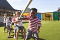 Group of school kids playing tug of war Royalty Free Stock Photo