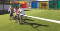 Group of school kids playing tug of war Royalty Free Stock Photo