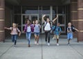 Group school school kids running as they leave the school building Royalty Free Stock Photo
