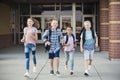 Group of school kids running as they leave elementary school at the end of day Royalty Free Stock Photo