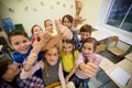 Group of school kids showing thumbs up