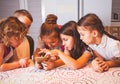 Group of school kids with smartphone having fun on break in classroom Royalty Free Stock Photo