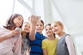 Group of school kids with smartphone and soda cans Royalty Free Stock Photo