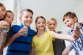 Group of school kids with smartphone and soda cans Royalty Free Stock Photo