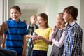 Group of school kids with soda cans in corridor Royalty Free Stock Photo