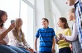 Group of school kids with soda cans in corridor Royalty Free Stock Photo