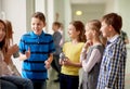 Group of school kids with soda cans in corridor Royalty Free Stock Photo