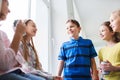 Group of school kids with soda cans in corridor Royalty Free Stock Photo