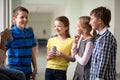 Group of school kids with soda cans in corridor Royalty Free Stock Photo