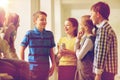 Group of school kids with soda cans in corridor