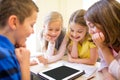 Group of school kids with tablet pc in classroom