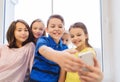 Group of school kids taking selfie with smartphone