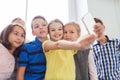 Group of school kids taking selfie with smartphone