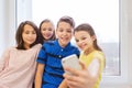 Group of school kids taking selfie with smartphone Royalty Free Stock Photo