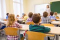 Group of school kids and teacher in classroom Royalty Free Stock Photo