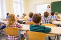 Group of school kids and teacher in classroom