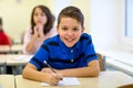 Group of school kids writing test in classroom Royalty Free Stock Photo