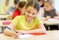 Group of school kids writing test in classroom Royalty Free Stock Photo