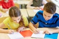 Group of school kids writing test in classroom Royalty Free Stock Photo