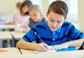 Group of school kids writing test in classroom Royalty Free Stock Photo