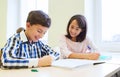 Group of school kids writing test in classroom Royalty Free Stock Photo