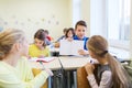 Group of school kids writing test in classroom Royalty Free Stock Photo