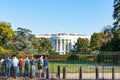 Group of school students standing outside at fence looking at White House, home of President or America