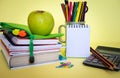 Group of school supplies and books over a yellow background, student accessories - copy space for text, back to school concept Royalty Free Stock Photo