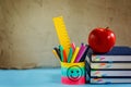 Group of school supplies and books and red apple over on backgro Royalty Free Stock Photo