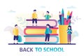 Group of schoolboys and schoolgirls near big books and stationery. Back to school banner concept. Education background
