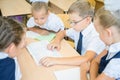 Group of schoolchildren at school classroom sitting at desk Royalty Free Stock Photo