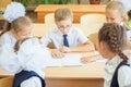 Group of schoolchildren at school classroom sitting at desk Royalty Free Stock Photo