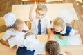 Group of schoolchildren at school classroom sitting at desk Royalty Free Stock Photo