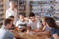 Group of schoolers discussing with teacher Royalty Free Stock Photo