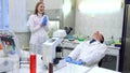 A group of scientists conducts research in a scientific laboratory using advanced technology. Scientists laugh, joked in