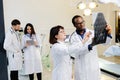 Group of scientists examining data on paper Royalty Free Stock Photo