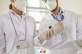 Group of scientists in white coats doing research in modern microbiological laboratory Royalty Free Stock Photo