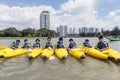 Group of secondary school children learn kayaking at Singapore river.