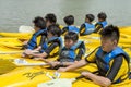 Group of secondary school children learn kayaking at Singapore river.