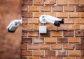 Group of security cameras on red brick wall Royalty Free Stock Photo