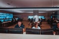 Group of Security data center operators working in a CCTV monitoring room looking on multiple monitors Officers Royalty Free Stock Photo