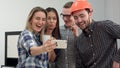 Group selfie shot of colleagues having fun in their office