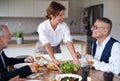 Group of senior friends at dinner party at home. Royalty Free Stock Photo