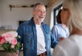 Group of senior friends at dinner party at home, greeting. Royalty Free Stock Photo