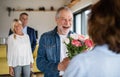 Group of senior friends at dinner party at home, greeting. Royalty Free Stock Photo